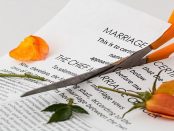 Scissors cutting marriage certificate