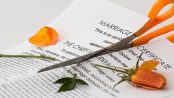 Scissors cutting marriage certificate